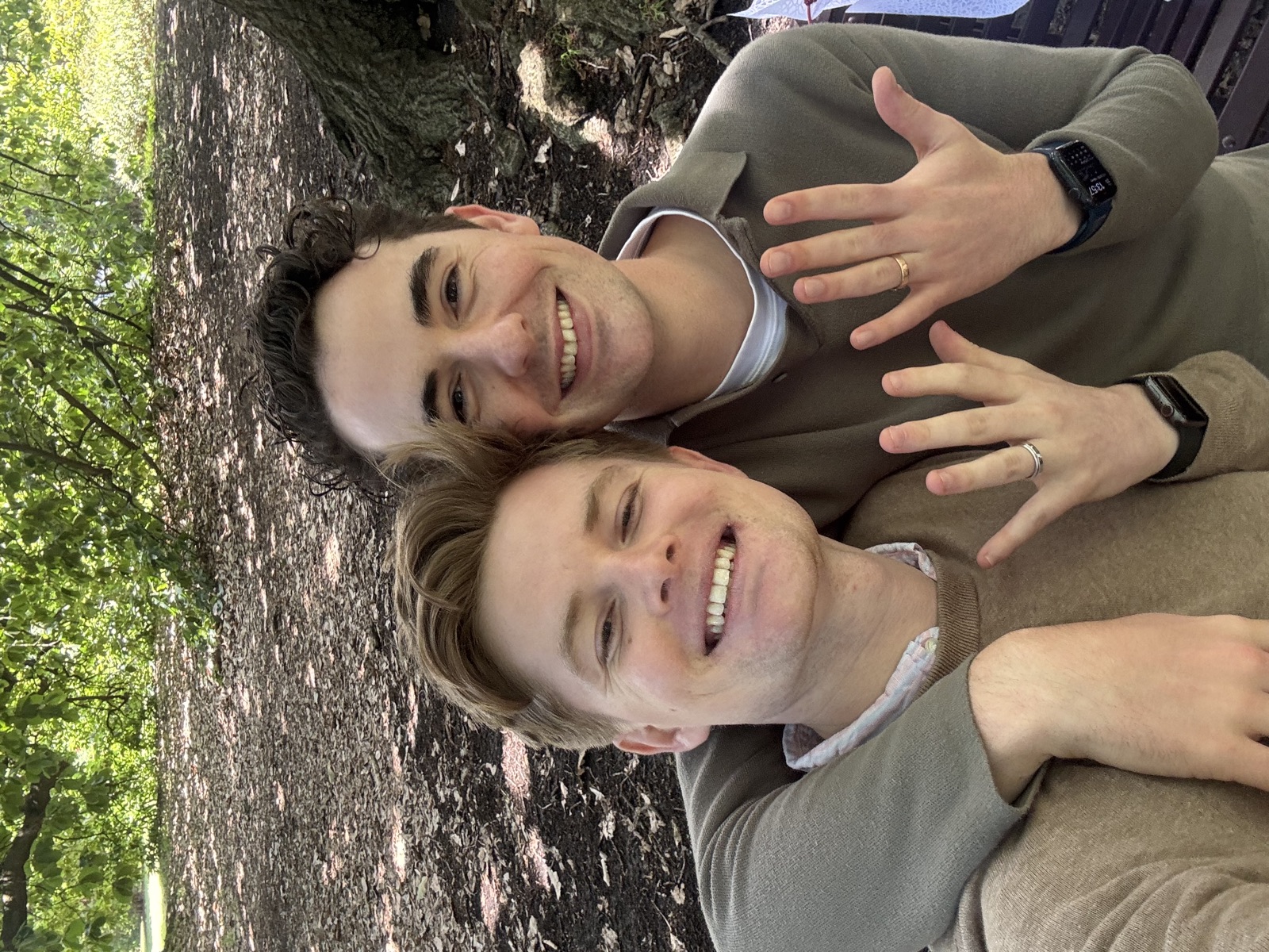 Lach and Bryce showing their engagement rings in the Royal Botanic Gardens